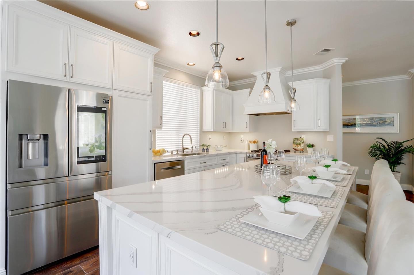 5889 Killarney Circle San Jose, CA 95138 - Photo 14 of 68 a kitchen with stainless steel appliances granite countertop a refrigerator a sink dishwasher and white cabinets with wooden floor