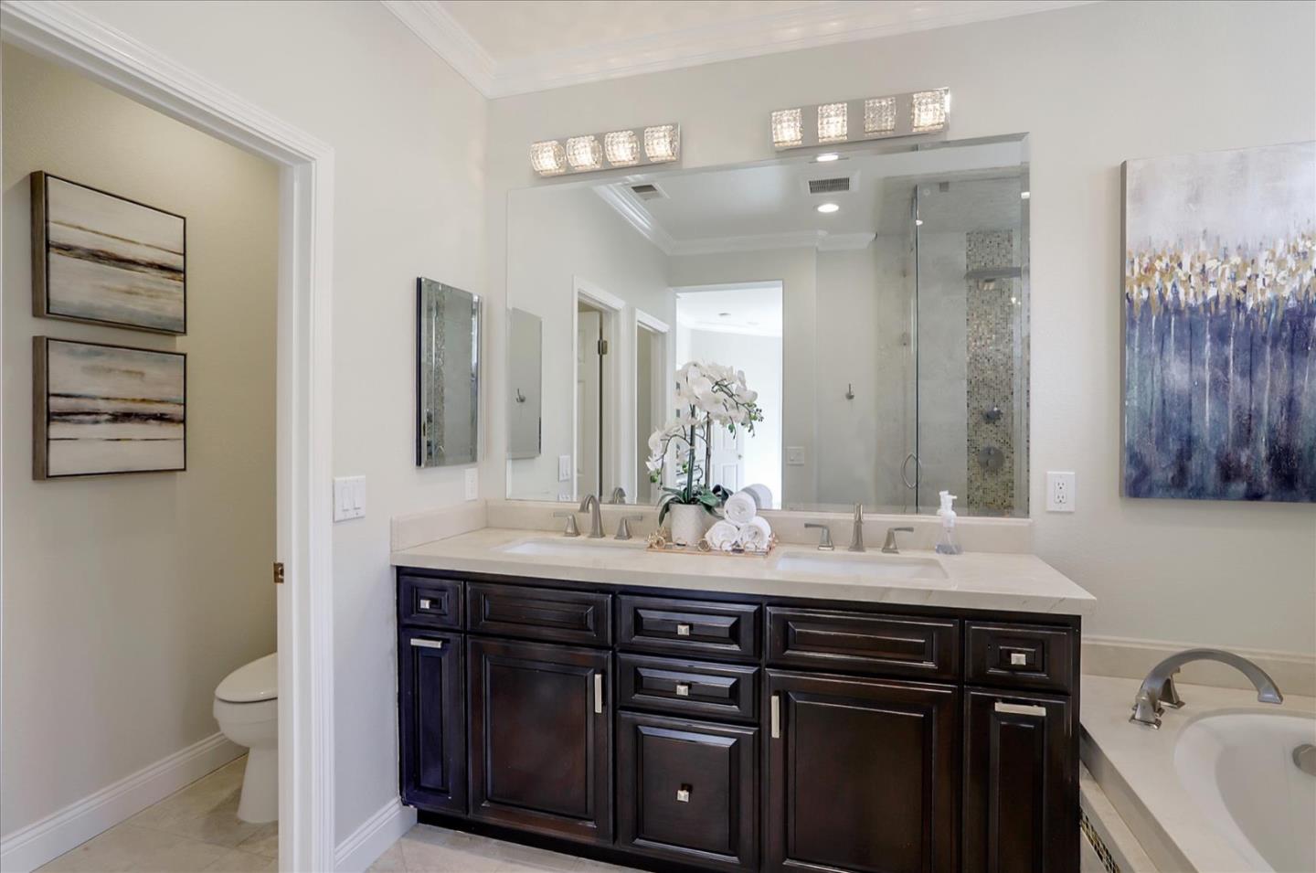 5889 Killarney Circle San Jose, CA 95138 - Photo 34 of 68 a bathroom with a granite countertop sink a toilet a mirror and shower