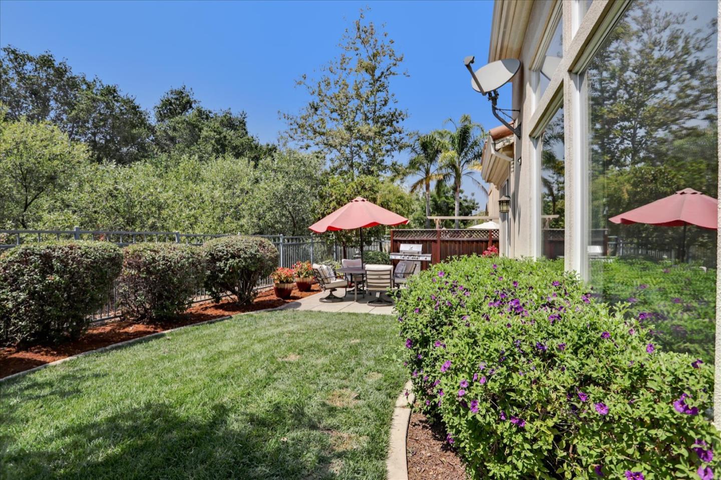 5889 Killarney Circle San Jose, CA 95138 - Photo 45 of 68 a view of a chair and table under an umbrella in backyard