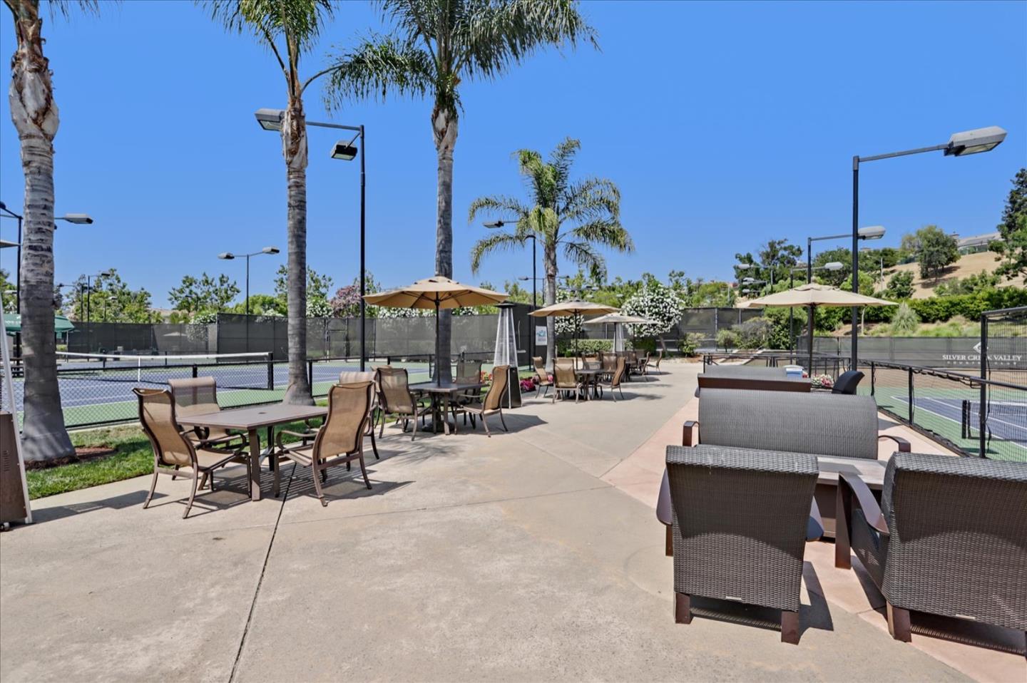5889 Killarney Circle San Jose, CA 95138 - Photo 56 of 68 a view of a patio with a table and chairs under an umbrella with potted plants