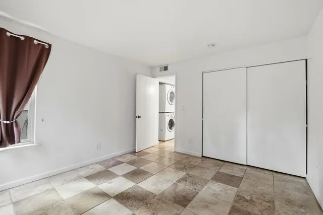a view of a refrigerator in kitchen and entryway