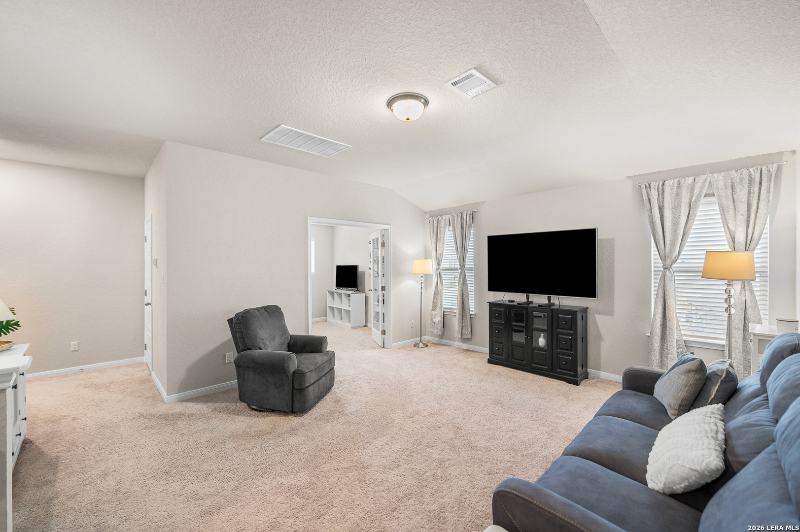 232 Colebrook Way Cibolo, TX 78108 - Photo 28 of 45 a living room with furniture and a flat screen tv