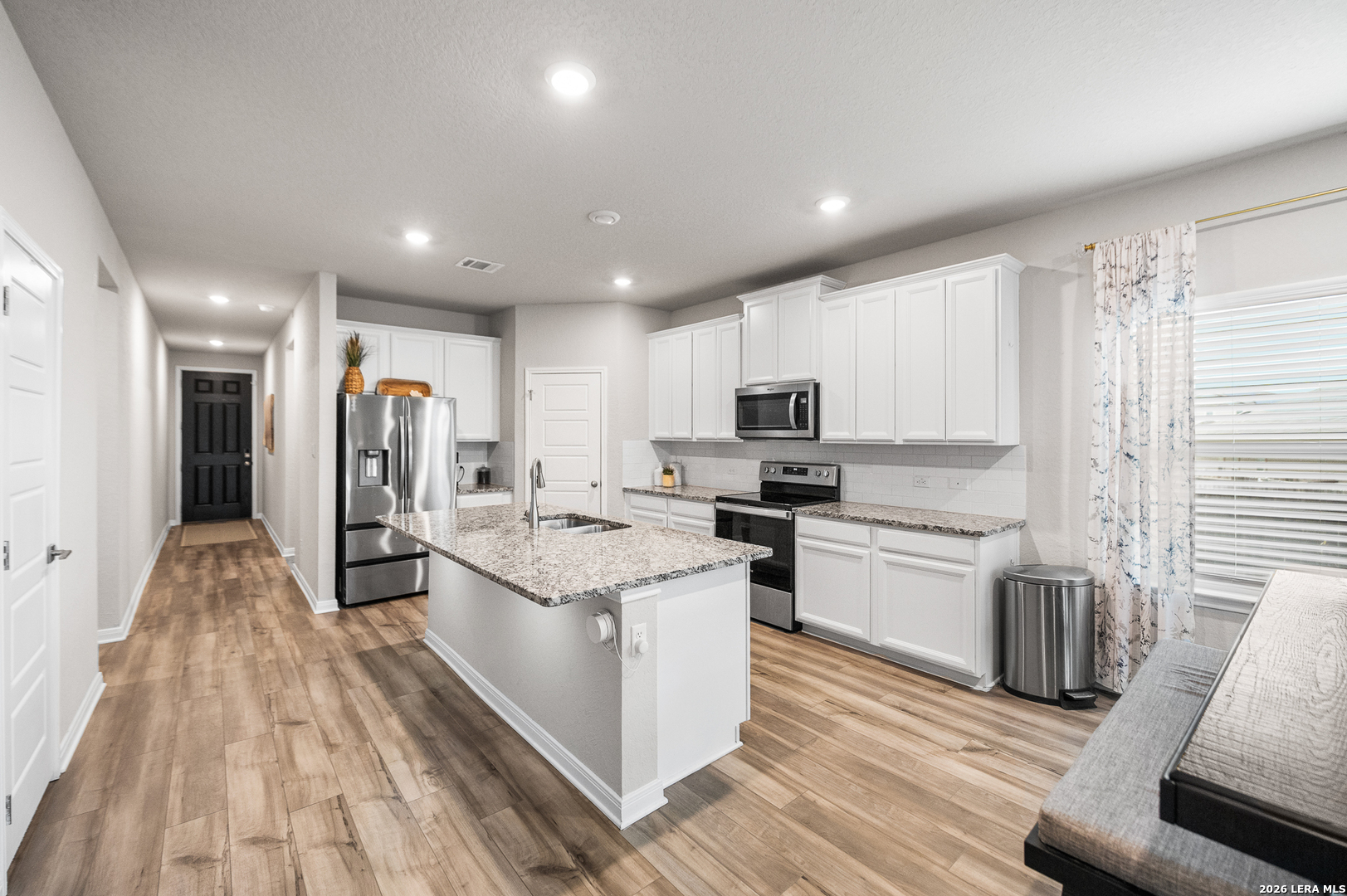 232 Colebrook Way Cibolo, TX 78108 - Photo 7 of 45 a kitchen with stainless steel appliances kitchen island granite countertop a stove and a refrigerator