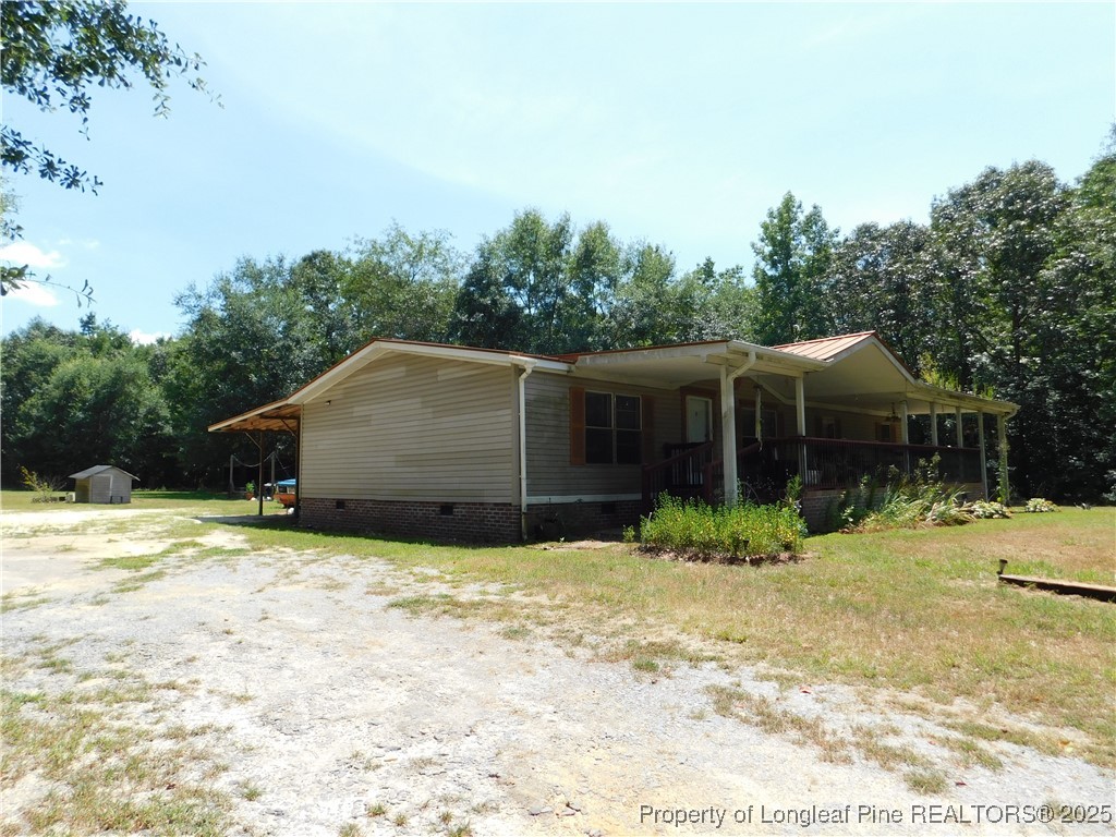 267 Ed Collins Lane Clinton, NC 28328 - Photo 3 of 45 a backyard of a house with large trees and covered with wooden fence