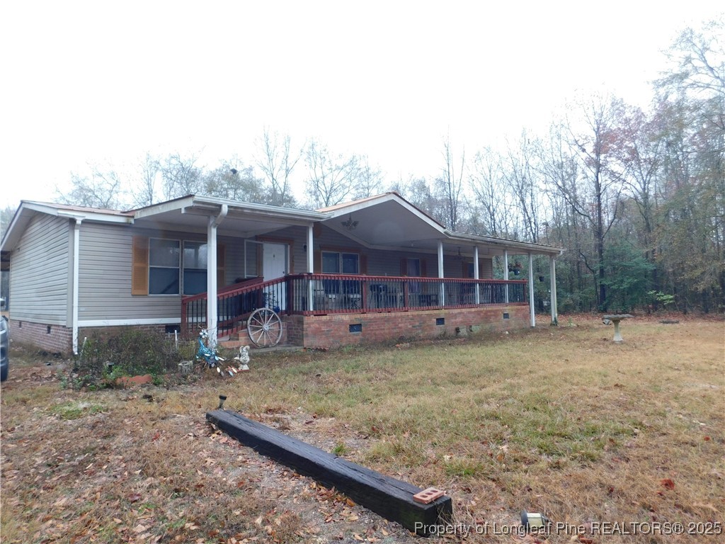 267 Ed Collins Lane Clinton, NC 28328 - Photo 4 of 45 a front view of a house with a garden and trees