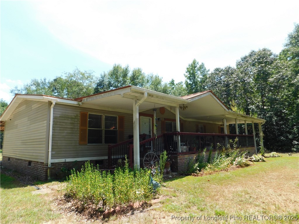 267 Ed Collins Lane Clinton, NC 28328 - Photo 5 of 45 a view of house with backyard and glass windows