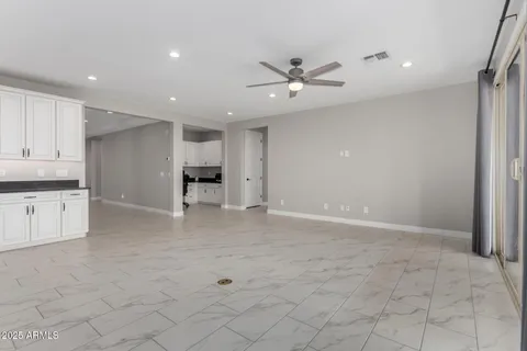 a view of an empty room with a kitchen