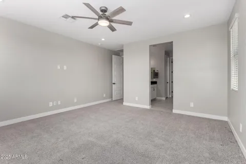 a view of an empty room with a ceiling fan