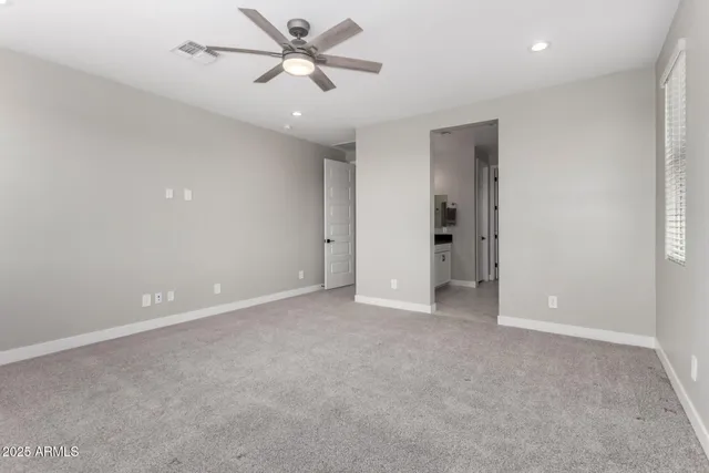 a view of an empty room with a ceiling fan