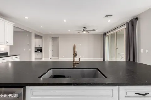 a kitchen with a sink and wooden cabinets