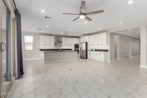 a view of kitchen with stainless steel appliances refrigerator oven and cabinets