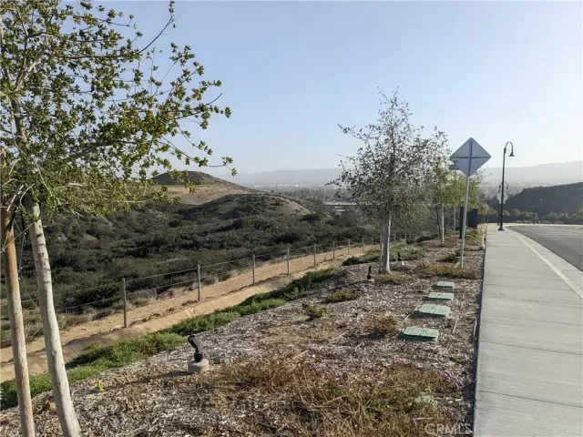 a view of a yard with wooden fence