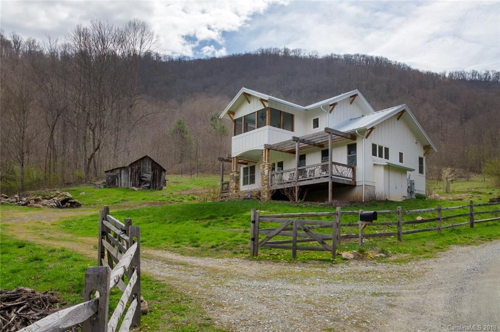 835 Secluded Valley Road Marshall, NC 28753 - Photo 2 of 21 an aerial view of a house with a yard table and chairs