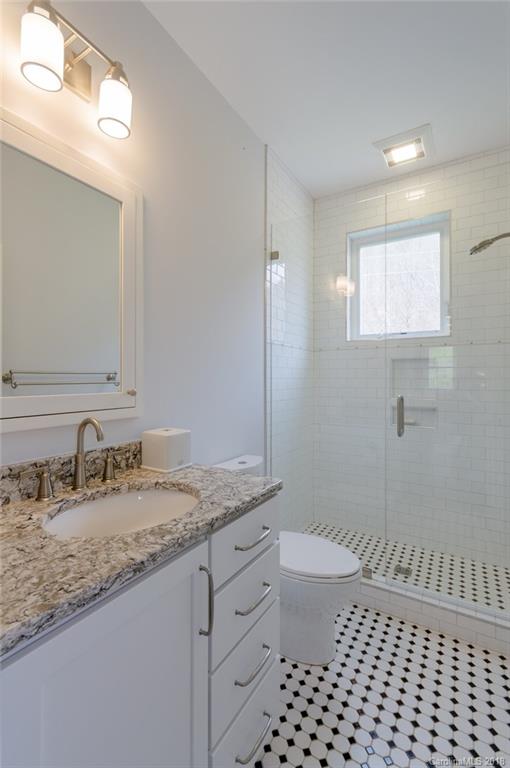 835 Secluded Valley Road Marshall, NC 28753 - Photo 13 of 21 a bathroom with a granite countertop sink a toilet and a mirror