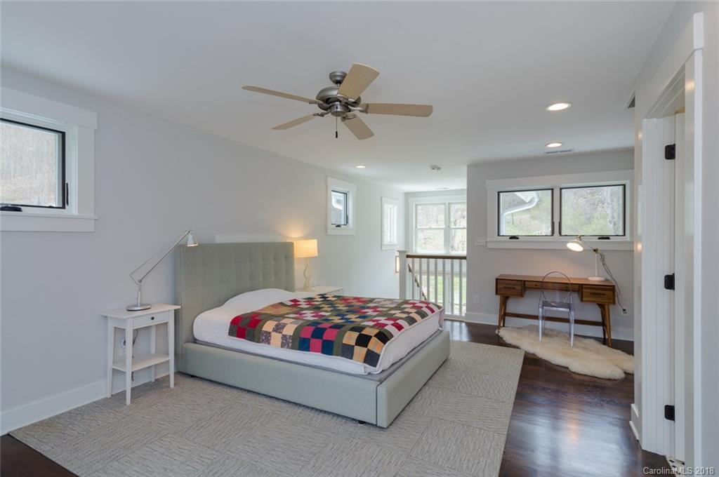 835 Secluded Valley Road Marshall, NC 28753 - Photo 14 of 21 a bedroom with a bed and wooden floor