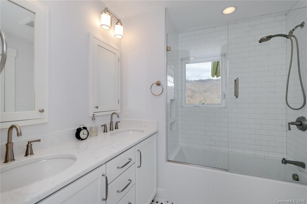 835 Secluded Valley Road Marshall, NC 28753 - Photo 15 of 21 a bathroom with a double vanity sink mirror and shower