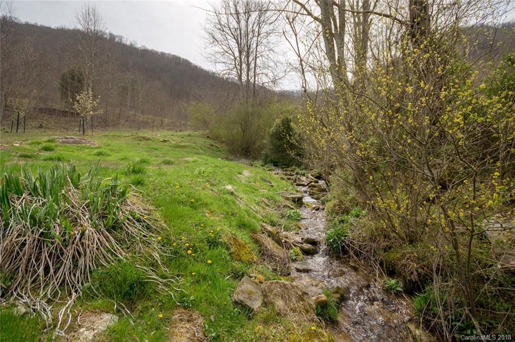835 Secluded Valley Road Marshall, NC 28753 - Photo 20 of 21 a backyard of a house with lots of green space