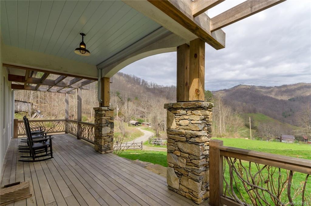 835 Secluded Valley Road Marshall, NC 28753 - Photo 3 of 21 a view of a balcony with chairs and wooden floor