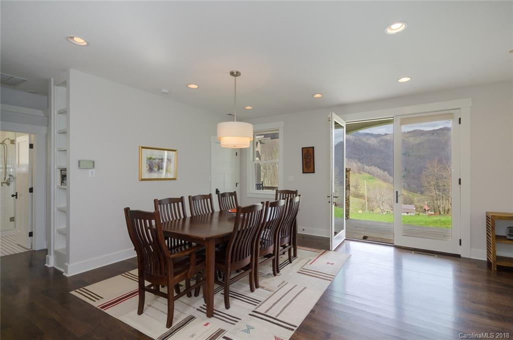 835 Secluded Valley Road Marshall, NC 28753 - Photo 6 of 21 a view of a dining room with furniture window and wooden floor
