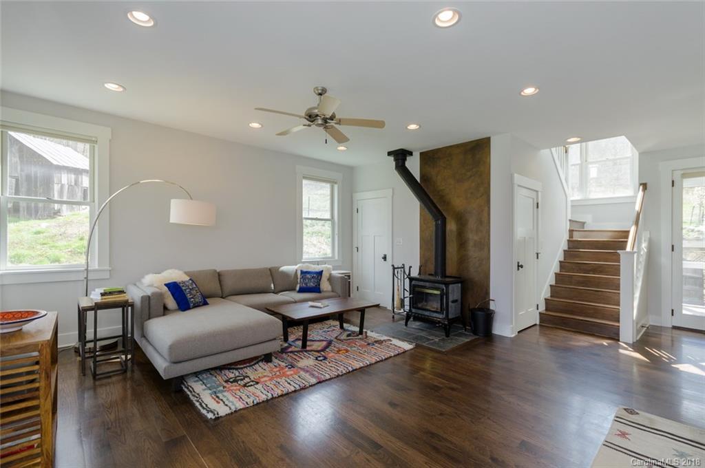 835 Secluded Valley Road Marshall, NC 28753 - Photo 7 of 21 a living room with furniture and a wooden floor