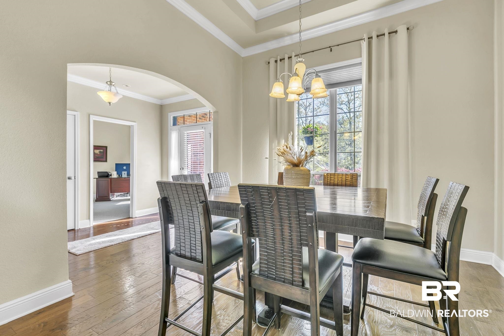 21439 Brick Stack Lane Fairhope, AL 36532 - Photo 6 of 32 Dining room featuring arched walkways, plenty of natural light, a chandelier, and hardwood / wood-style flooring