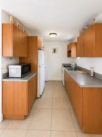 a kitchen with stainless steel appliances granite countertop a sink counter space and cabinets