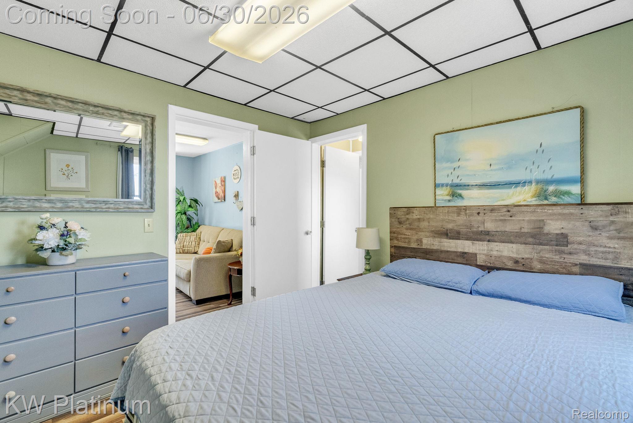 2235 South Lake Shore Road Harbor Beach, MI 48441 - Photo 73 of 99 Bedroom featuring a paneled wood-finish headboard, light green walls, and a white ceiling with black grid accents