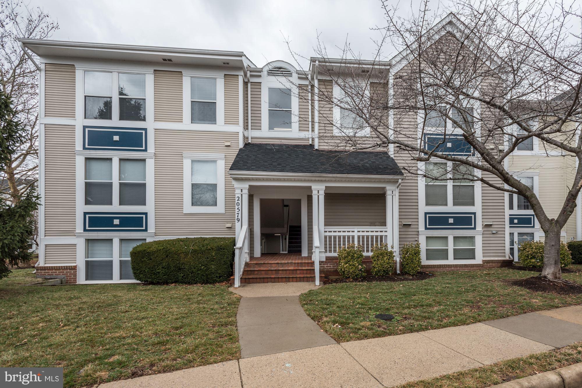 20579 Snowshoe Square, Unit 301 Ashburn, VA 20147 - Photo 1 of 30 a front view of a house with garden and entryway