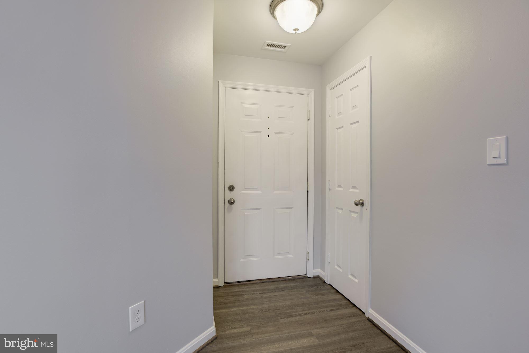20579 Snowshoe Square, Unit 301 Ashburn, VA 20147 - Photo 2 of 30 a view of hallway with wooden floor