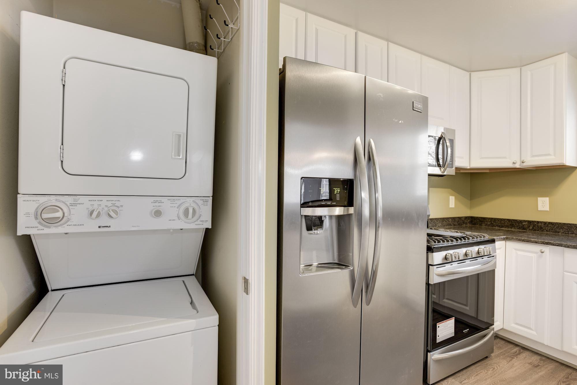 20579 Snowshoe Square, Unit 301 Ashburn, VA 20147 - Photo 14 of 30 a kitchen with a refrigerator and washer