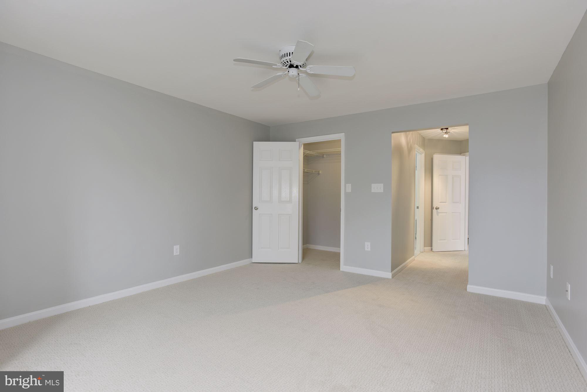 20579 Snowshoe Square, Unit 301 Ashburn, VA 20147 - Photo 17 of 30 a view of an empty room with a ceiling fan