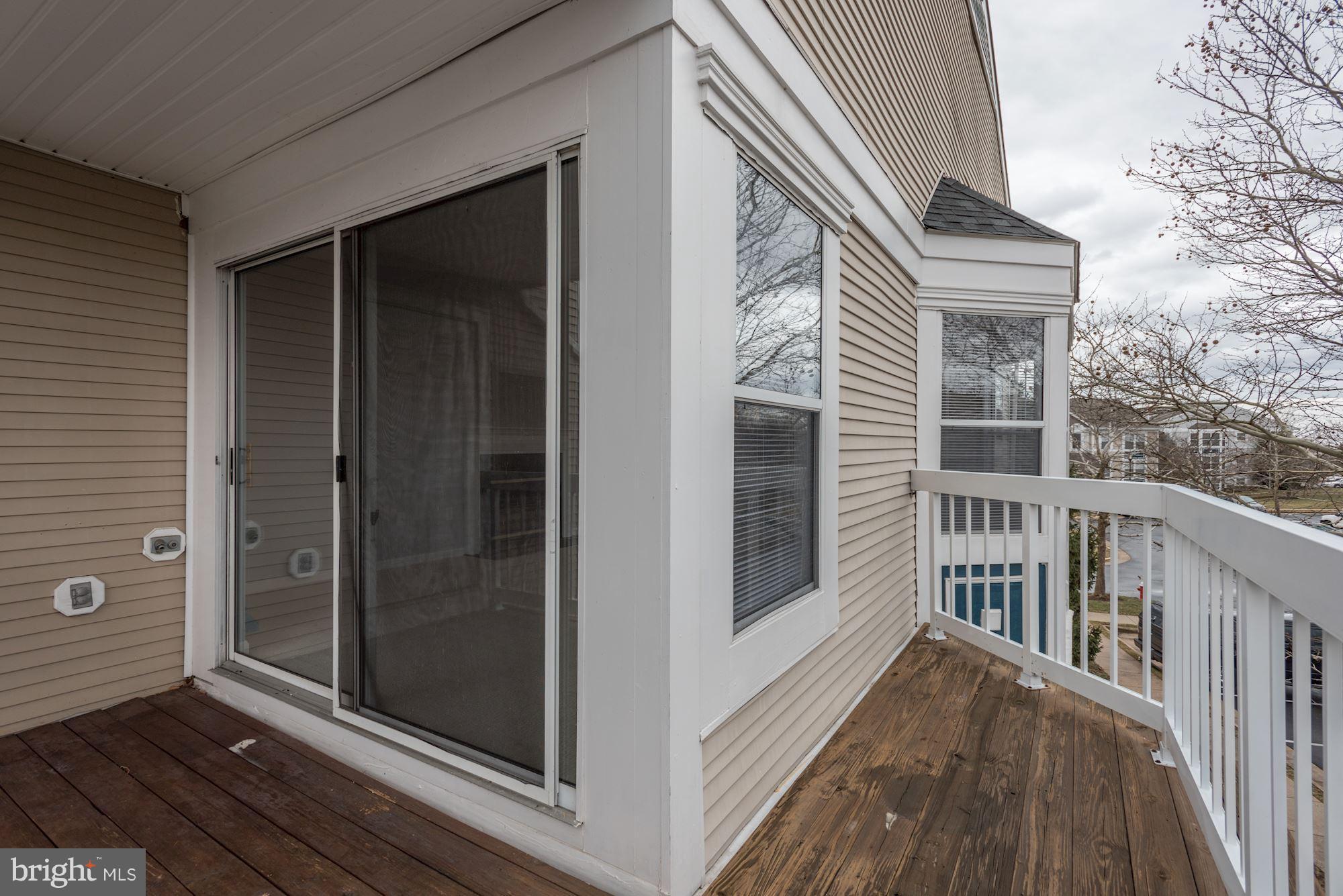 20579 Snowshoe Square, Unit 301 Ashburn, VA 20147 - Photo 20 of 30 a view of a balcony with furniture and floor to ceiling window