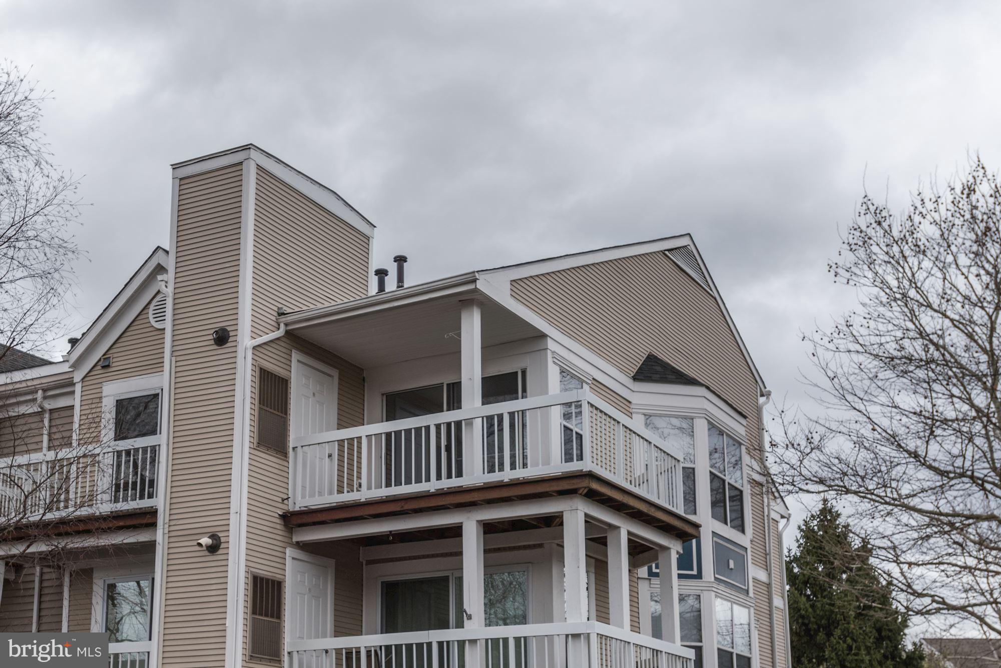 20579 Snowshoe Square, Unit 301 Ashburn, VA 20147 - Photo 30 of 30 a view of a house with a yard and balcony