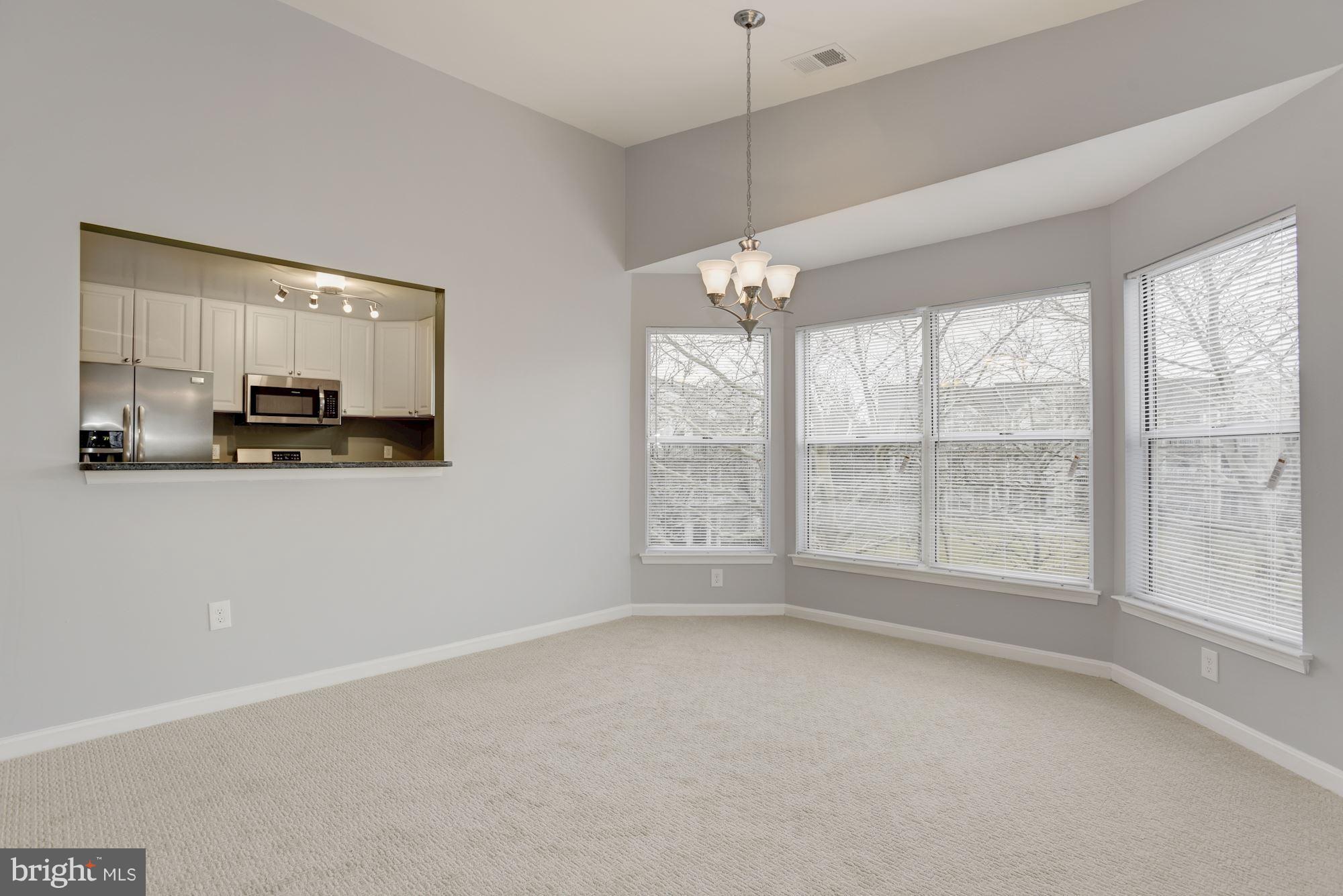 20579 Snowshoe Square, Unit 301 Ashburn, VA 20147 - Photo 5 of 30 a view of an empty room with a window