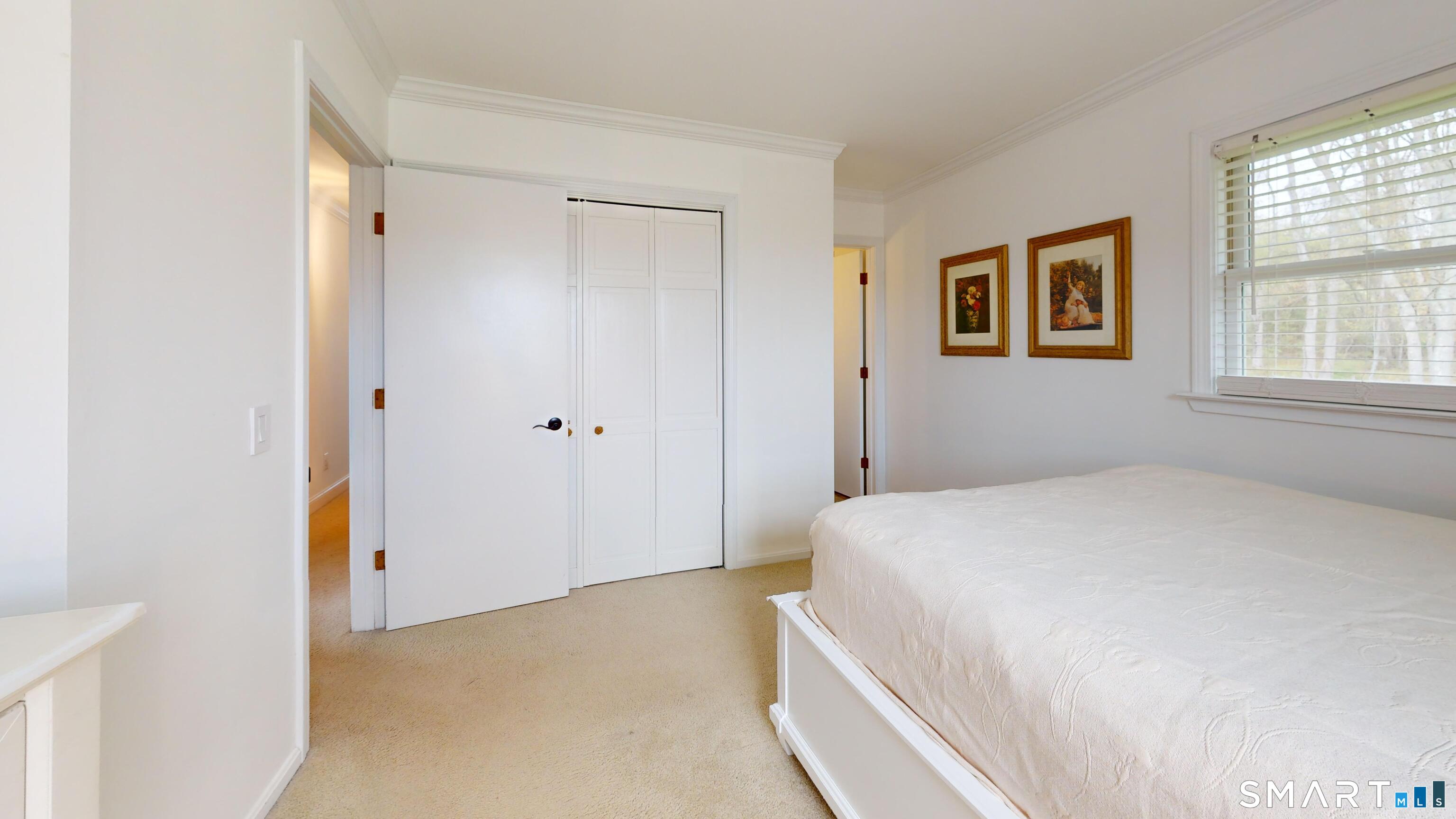 29 Deer Ridge Road Stonington, CT 06378 - Photo 14 of 35 a bedroom with a bed and a window