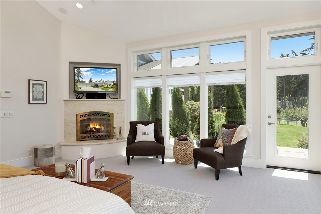 530 Bayside Road Bellingham, WA 98225 - Photo 22 of 40 a living room with furniture a flat screen tv and a fireplace