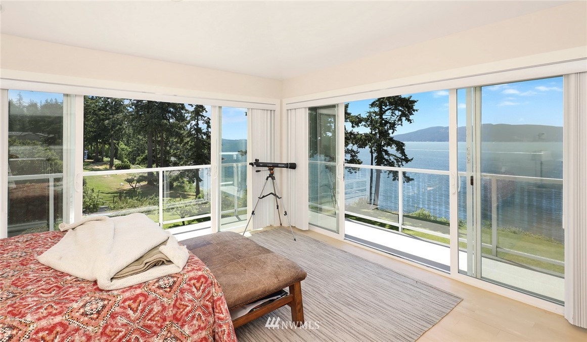 530 Bayside Road Bellingham, WA 98225 - Photo 30 of 40 a bedroom with a bed and glass door