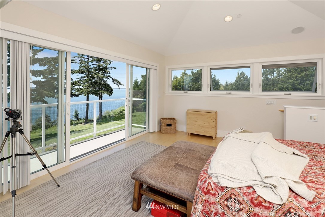 530 Bayside Road Bellingham, WA 98225 - Photo 32 of 40 a bedroom with a bed and wooden floor