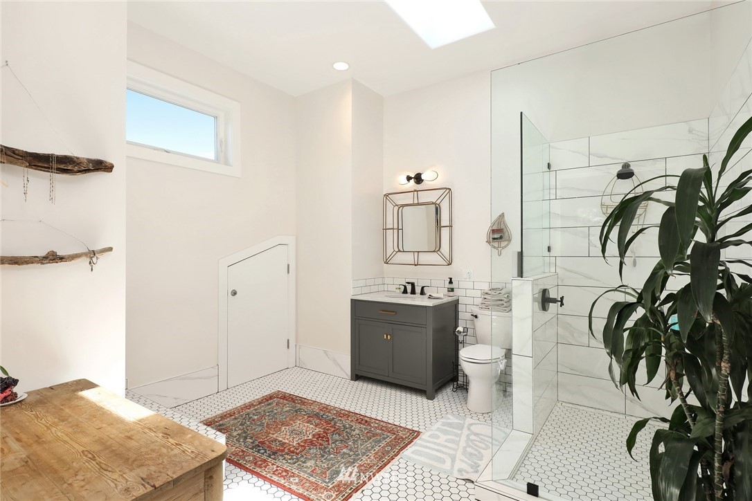 530 Bayside Road Bellingham, WA 98225 - Photo 33 of 40 a spacious bedroom with a bed and a potted plant