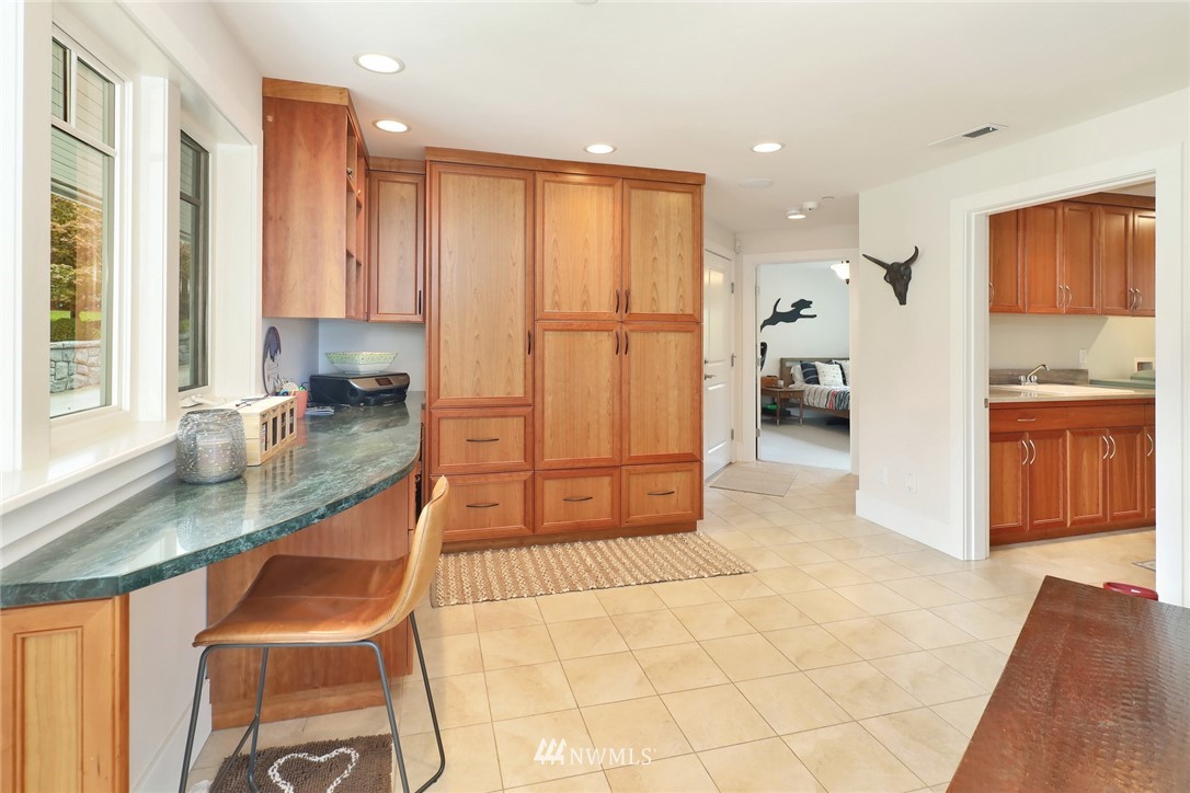 530 Bayside Road Bellingham, WA 98225 - Photo 38 of 40 a kitchen with stainless steel appliances granite countertop a sink refrigerator and cabinets