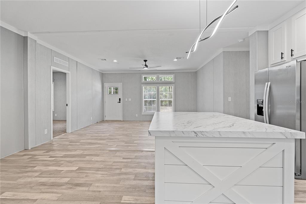 375 Sapp Street Inglis, FL 34449 - Photo 12 of 36 a large white bed in a white room with closet and entryway