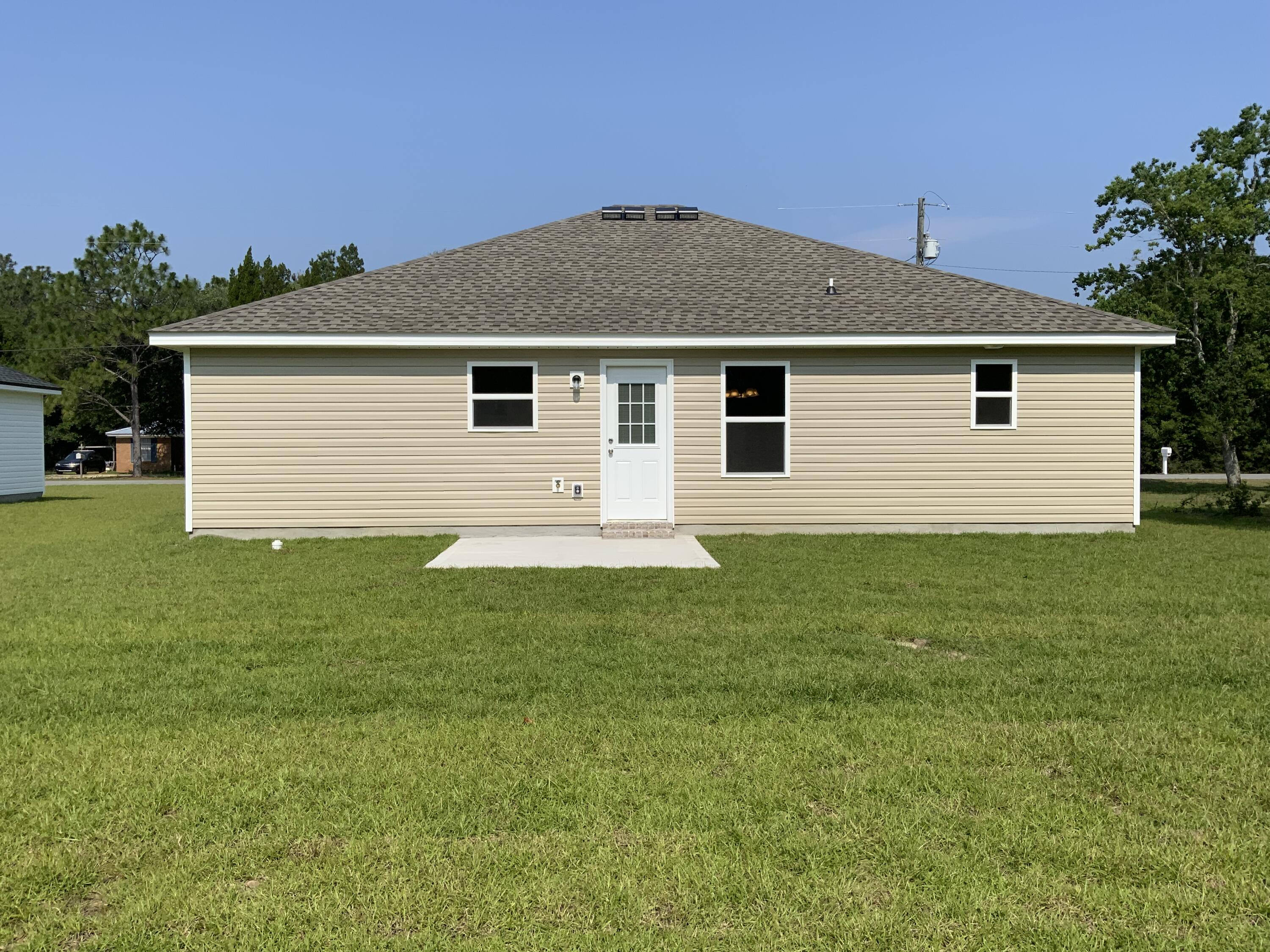 5835 Flamingo Road Crestview, FL 32539 - Photo 11 of 12 a front view of house with yard and trees