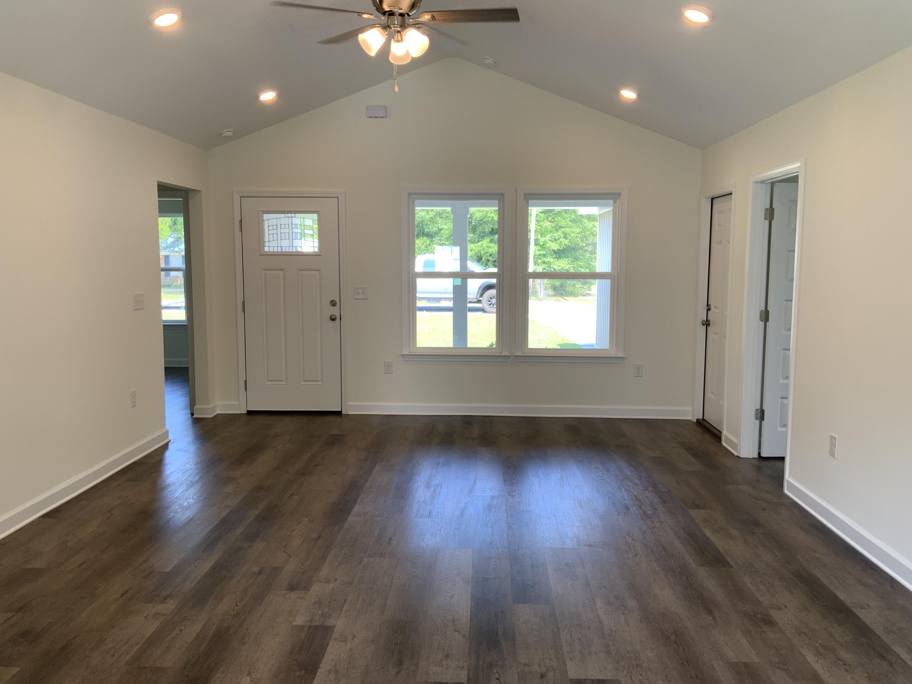 5835 Flamingo Road Crestview, FL 32539 - Photo 2 of 12 an empty room with wooden floor and windows