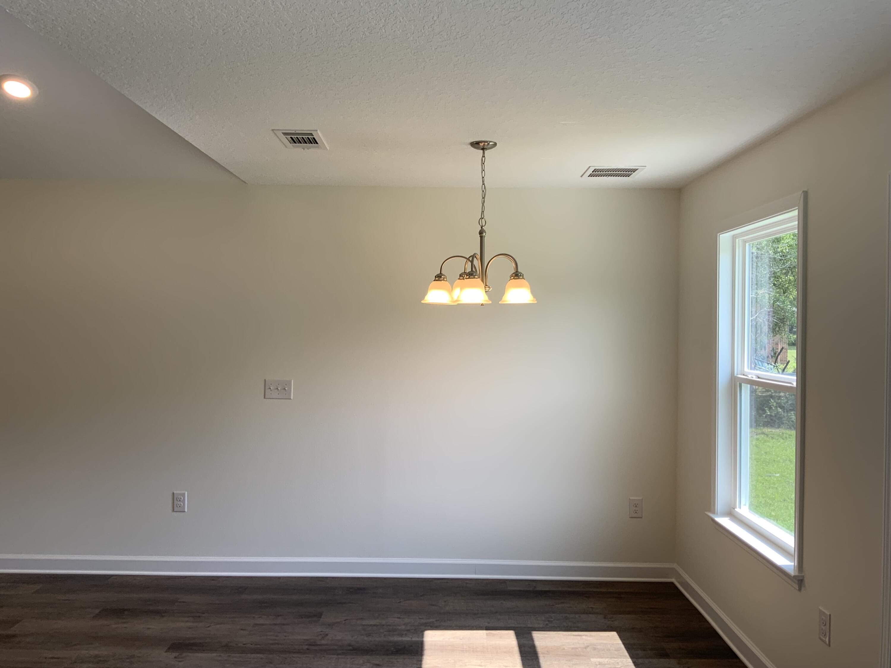 5835 Flamingo Road Crestview, FL 32539 - Photo 5 of 12 a view of room with window and hardwood floor