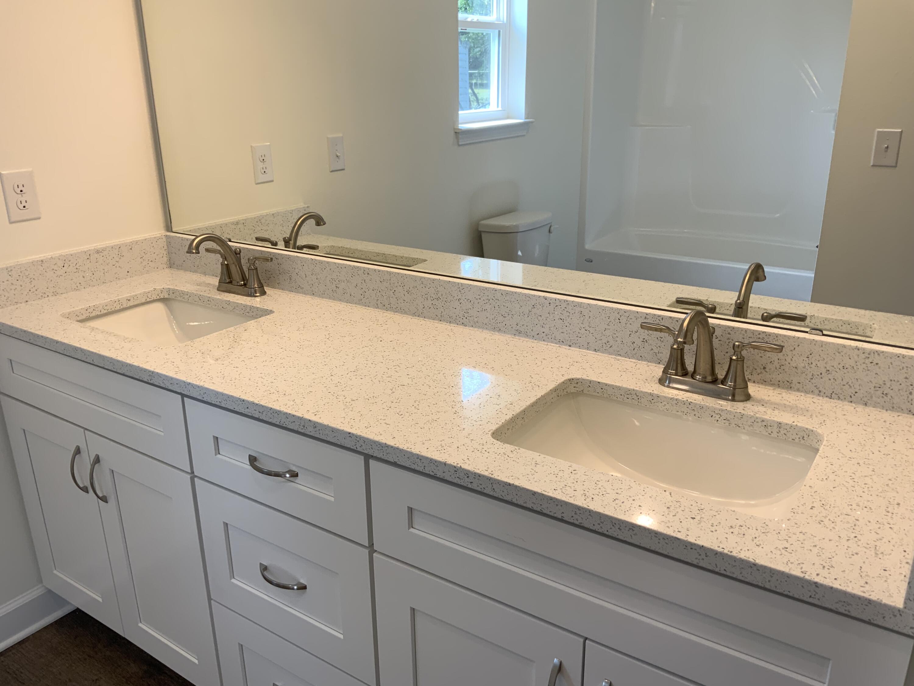 5835 Flamingo Road Crestview, FL 32539 - Photo 7 of 12 a bathroom with double sink and a mirror