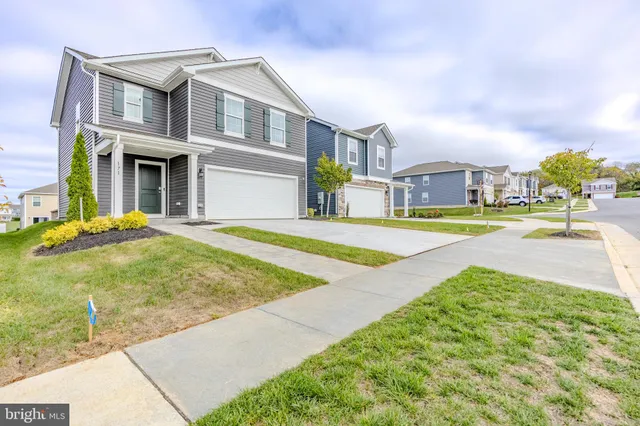 a view of an house with swimming pool and sitting area