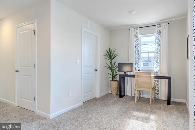 a bedroom with bed and a large window