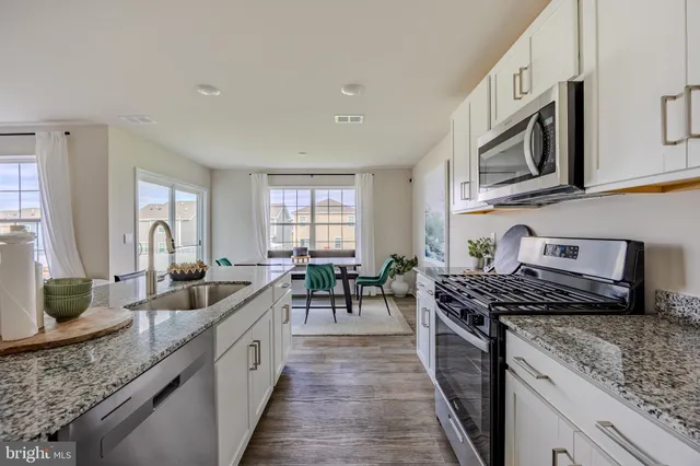 a bedroom with a bed and painting on the wall