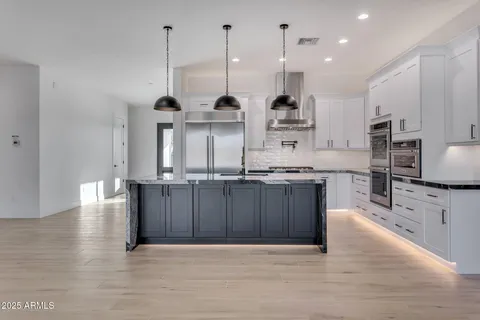 a view of kitchen and kitchen with furniture appliances