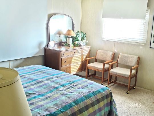 71 Adams Road Wofford Heights, CA 93285 - Photo 11 of 27 a bedroom with a bed and a chair